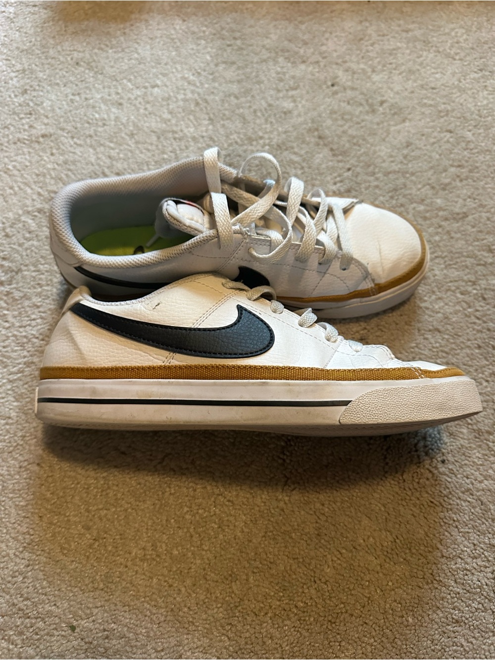 Nike White Sneakers with Black Swoosh and Gold/Brown Accent